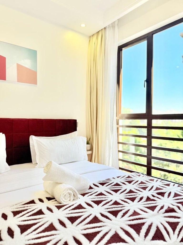 large windows in a bedroom at Furnished Apartment near Netherlands Embassy