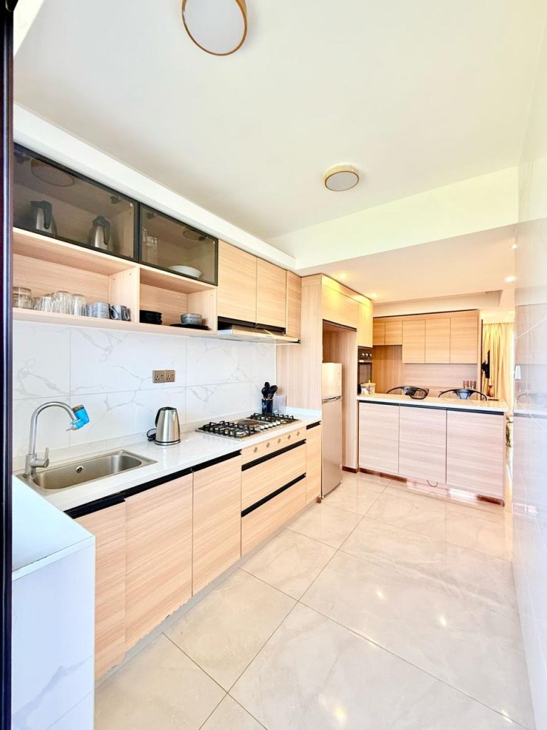 Expansive and fitted open plan kitchen at the Fully Furnished 3 bedroom Apartment in Westlands with cabinets and appliances