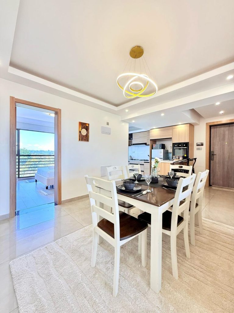 The dining area space with the partial view of the dininga area and a bedroom at the Fully Furnished 3 bedroom Apartment in Westlands