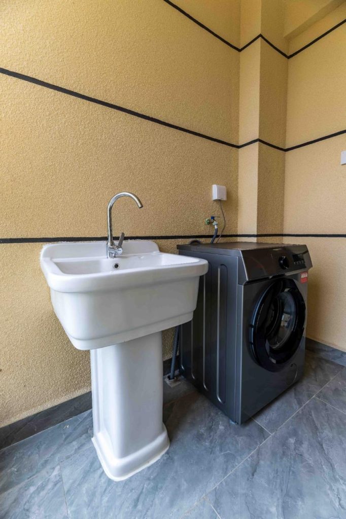 Laundry area with a machine at the Family-friendly serviced apartment in Kilimani