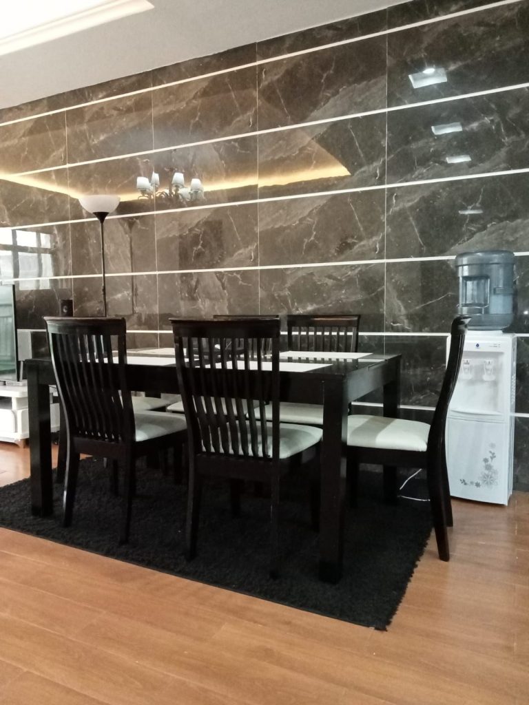 dinning area set for six and water dispencer at the back at the Budget 2 bedroom furnished apartment Kilimani