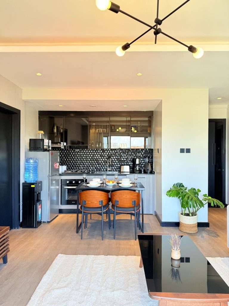 fitted open plan kitchen with cabinets and appliances at the Furnished Apartment for Digital Nomads in Nairobi
