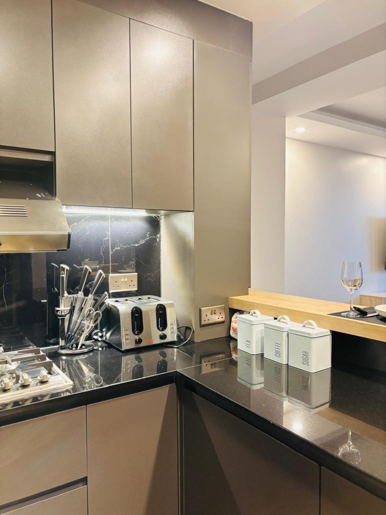 a toaster,cutlery and provisions at the Furnished 3 bedroom Apartment in Gated Community