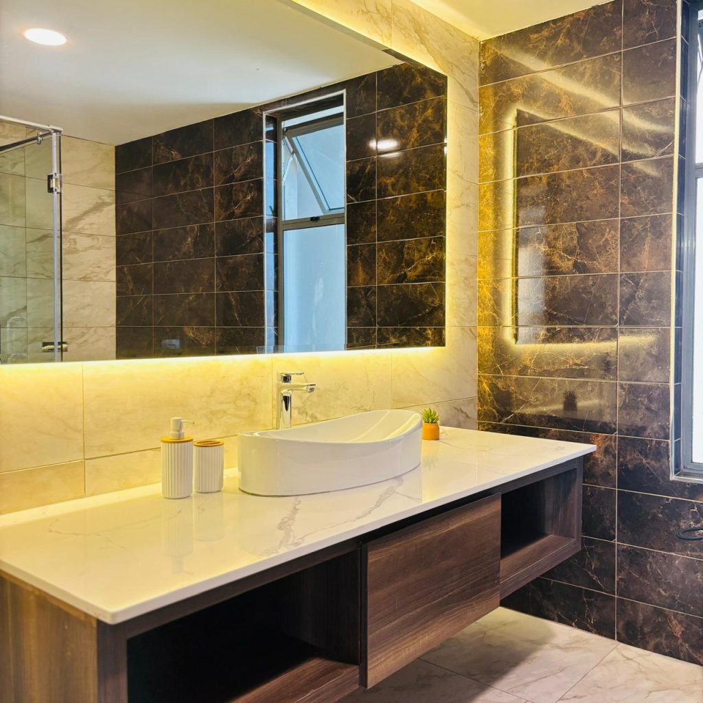 an expansive sink with storage spaces and a mirror at Furnished 3 bedroom Apartment in Gated Community