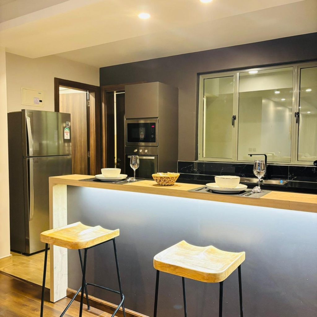 An island kitchen at the Furnished 3 bedroom Apartment in Gated Community