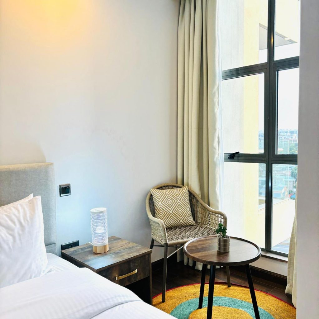 an accent chair with a small table at the Furnished 3 bedroom Apartment in Gated Community