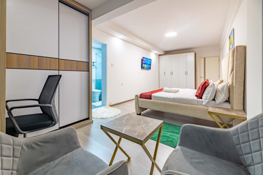 the master bedroom ensuite with study desk and a chair at 3 bedroom furnished apartment in Nairobi