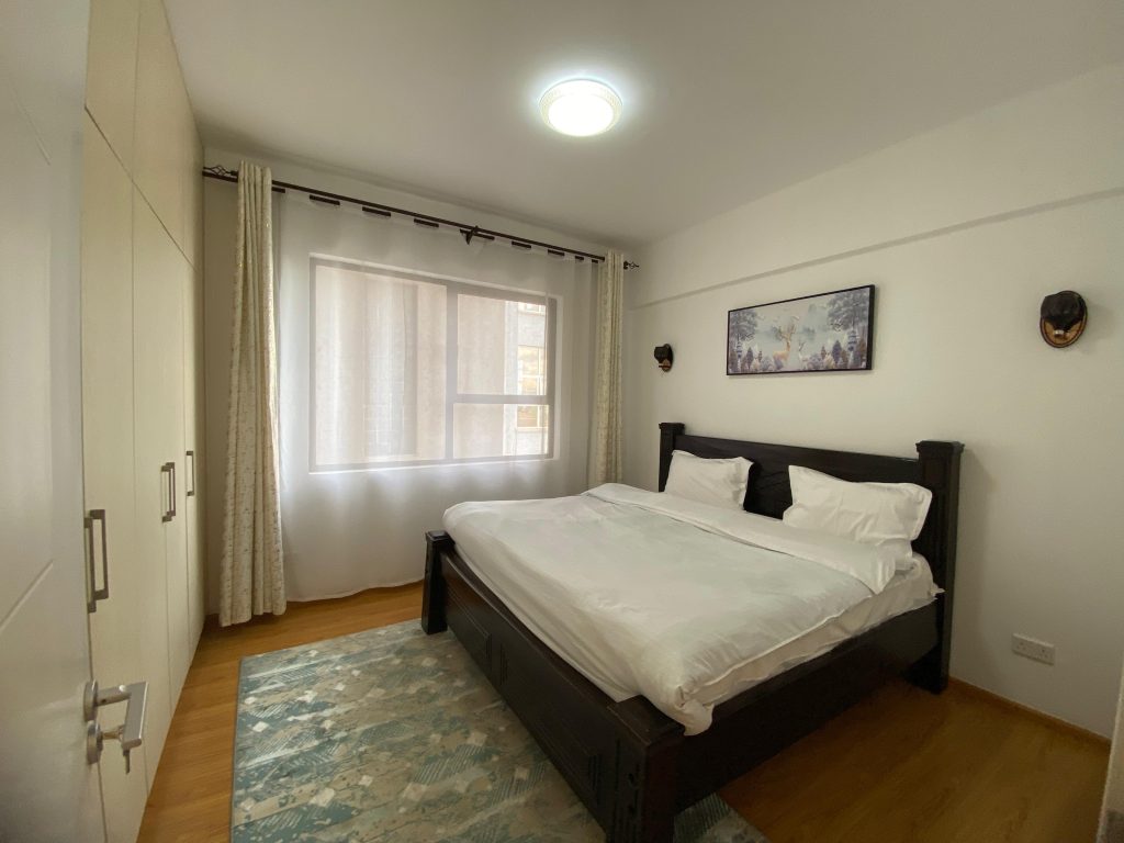 bedroom with the view of large windows a and a queen size bed and white bedings at Furnished 3 Bedroom Apartment For rent in Kenya
