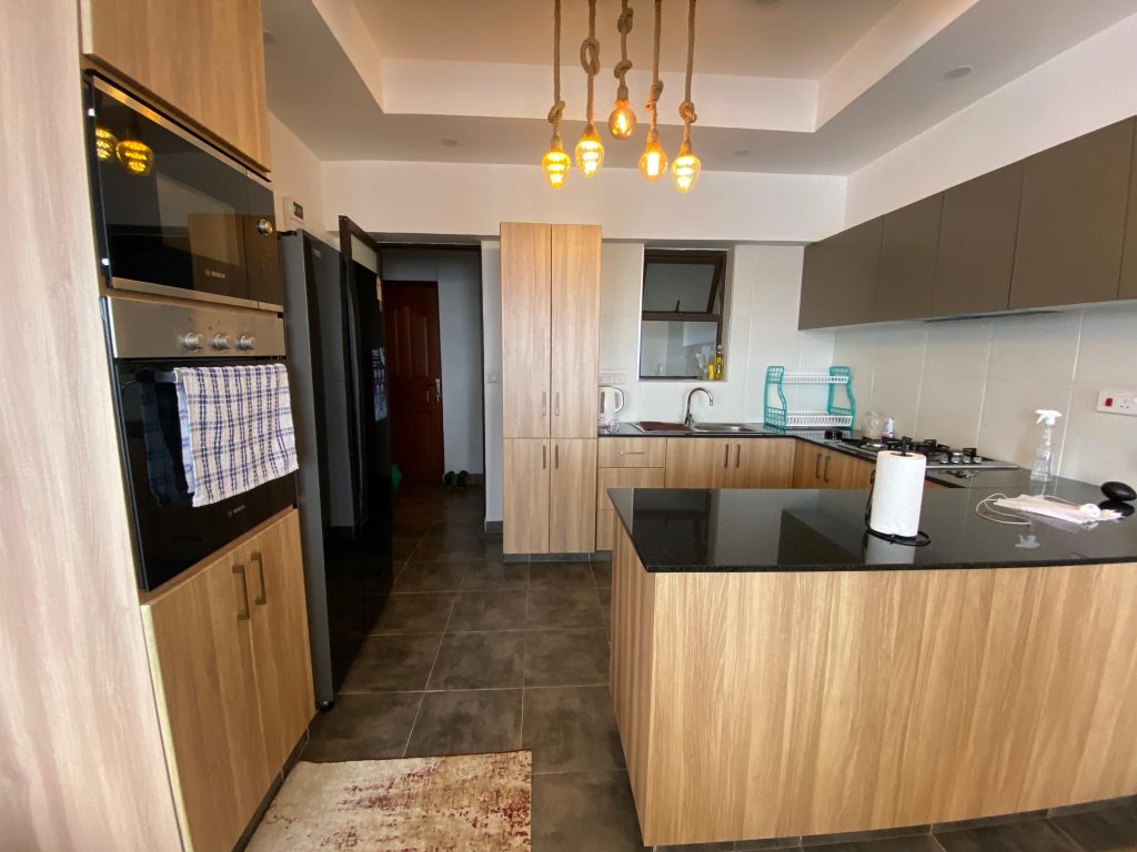 fitted kitchen with cabinets and appliances at Furnished 3 Bedroom Apartment For rent in Kenya
