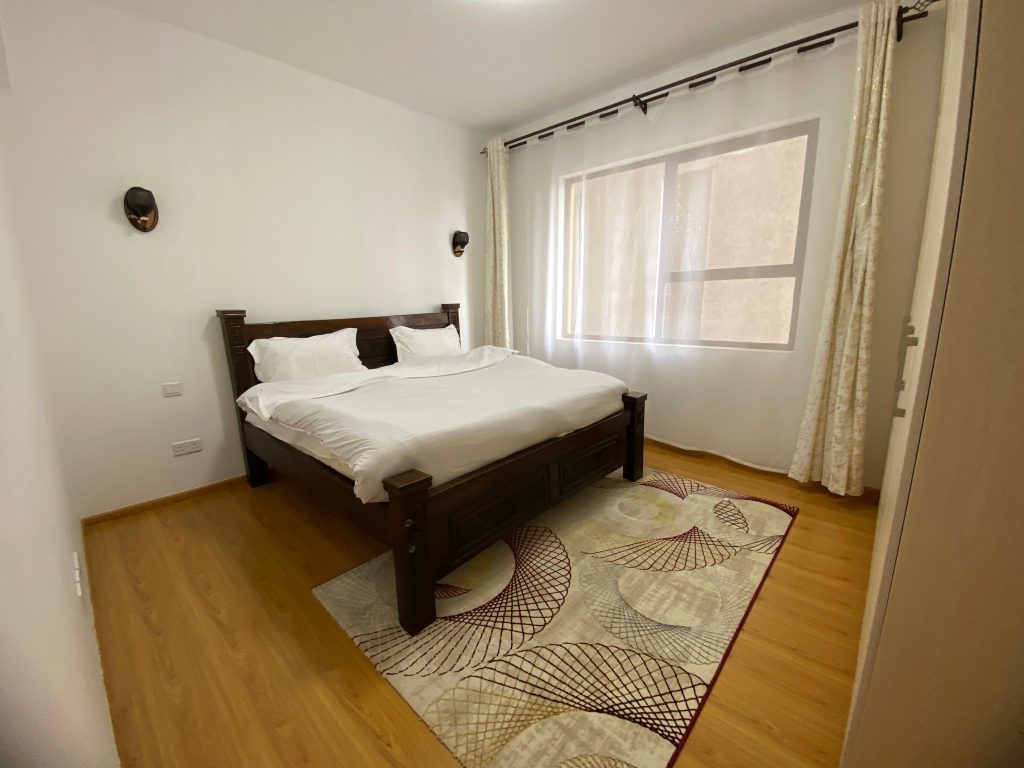 bedroom with a queen size bed, in built wardrobes and large windows at Furnished 3 Bedroom Apartment For rent in Kenya