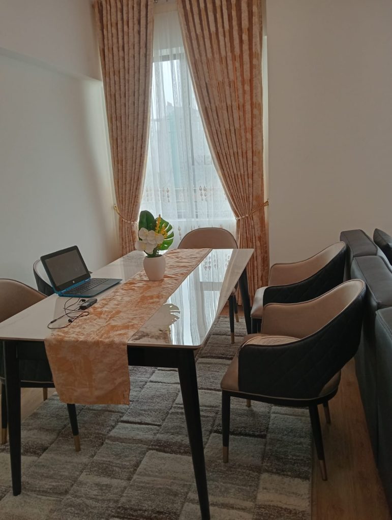 the dining table set up for five at the Furnished 2-Bedroom Apartment for Daily Rentals in Kilimani
