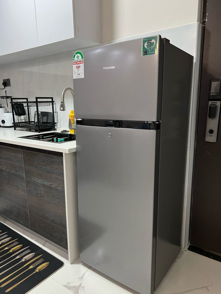 the view of the fridge ,sink and dish rack at the Furnished 2 bedroom Apartment Ideal for Extended Stay