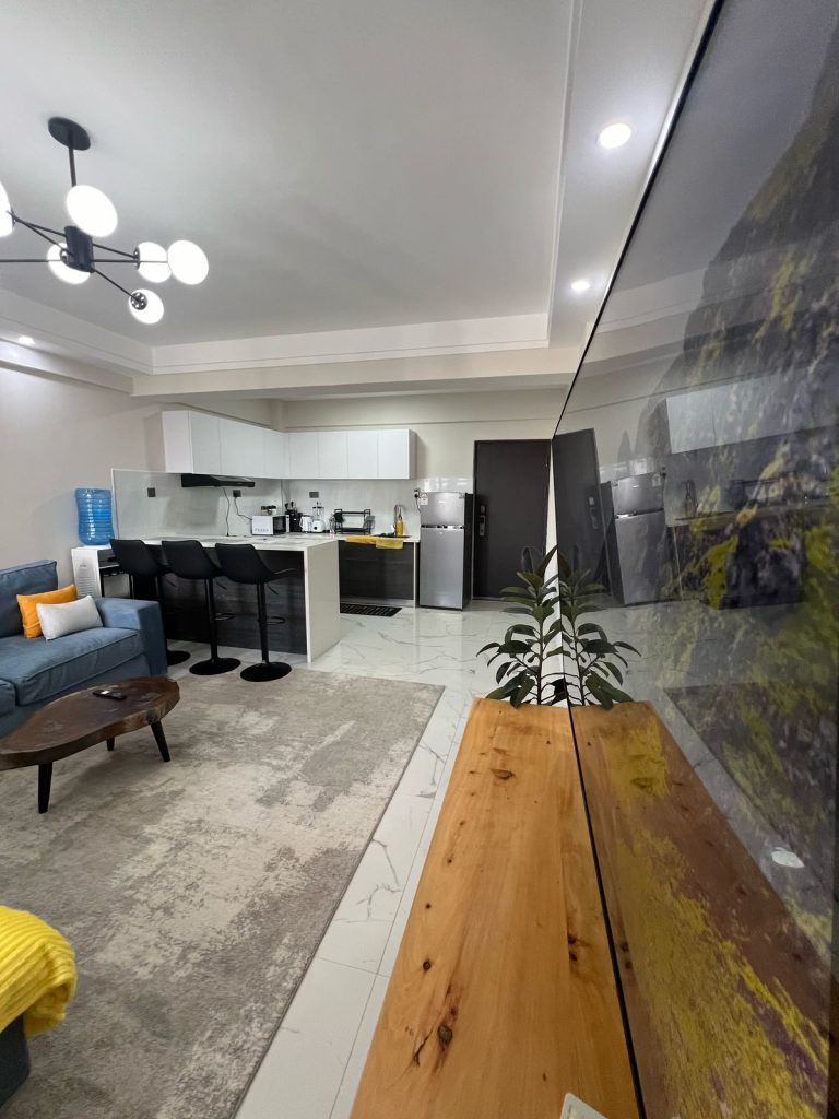 view of the open plan kitchen and partial view of the couch at the Furnished 2 bedroom Apartment Ideal for Extended Stay