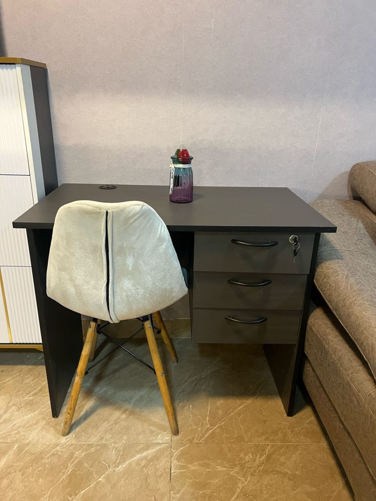 a study desk with a chair at Furnished Apartment with Rooftop Terrace in Kilimani