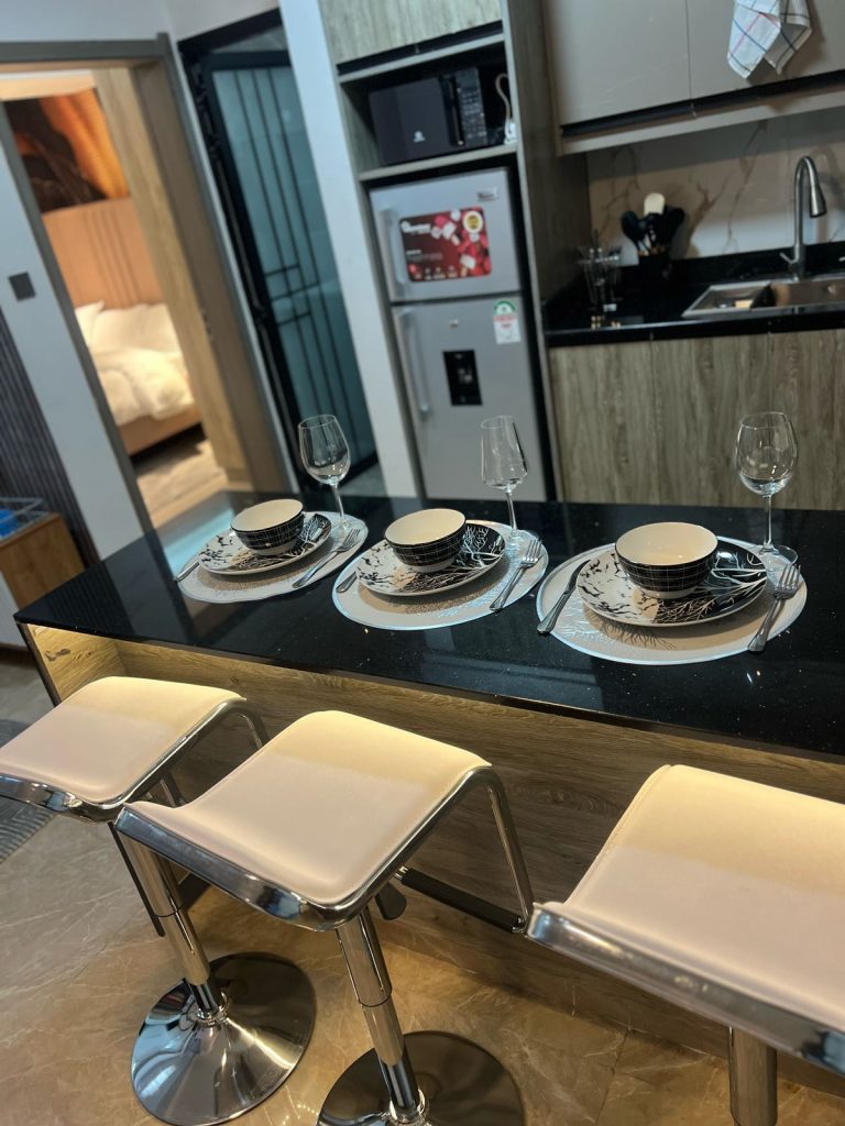 a kitchen island or breakfast bar at Furnished Apartment with Rooftop Terrace in Kilimani