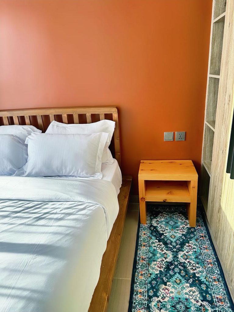 partial view of a bed and a nightstand table at the Serviced 1 Bedroom Apartment In Kilimani