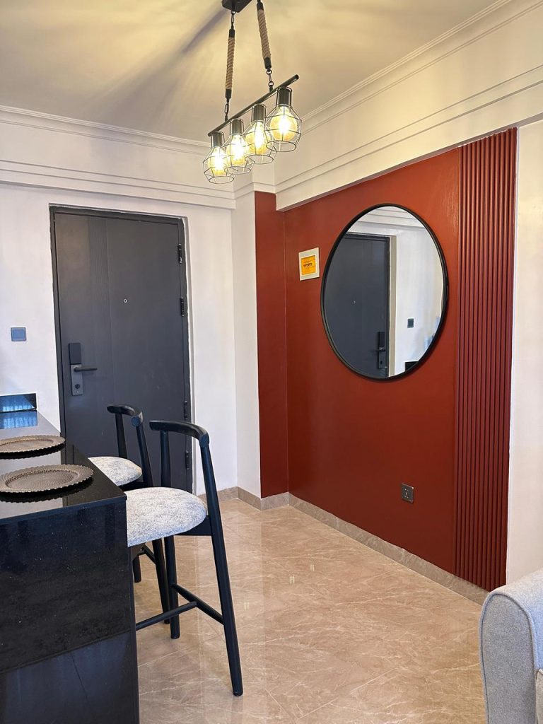 the breakfast bar with 2 seats and a mirror at Serviced 1 Bedroom Apartment In Kilimani