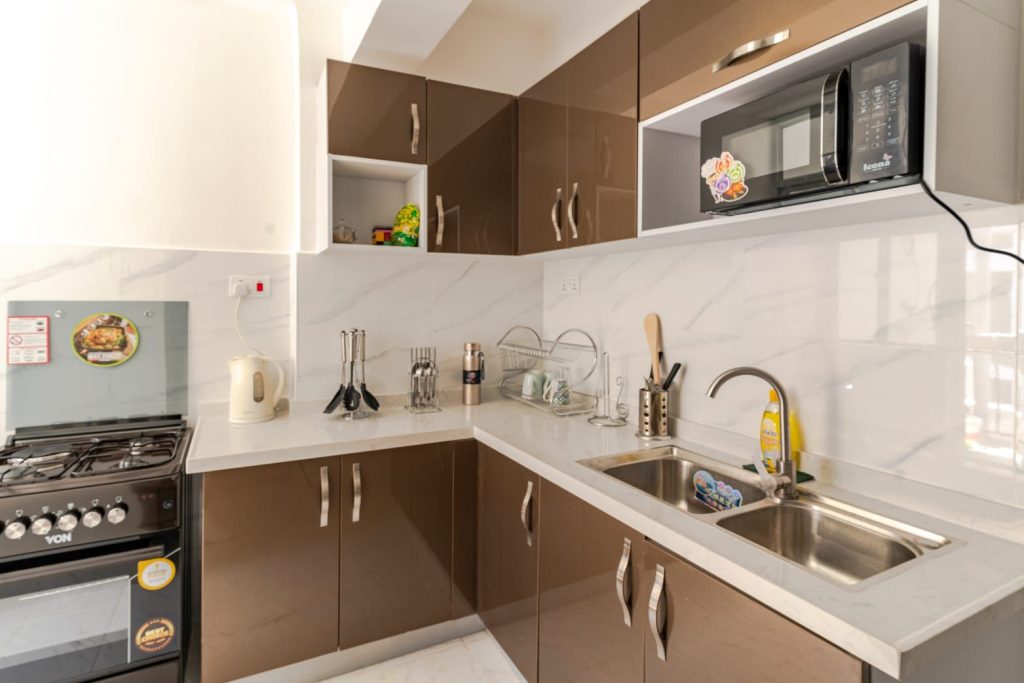 closer view of the open plan kitchen cabinets and appliances at the Extended Stay Furnished Apartment in Nairobi