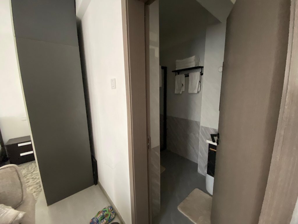 bathroom view with towels view from the entrance at Furnished Studio Apartment in Kilimani