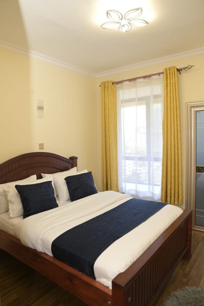 1st bedroom view large windows with curtains at Best Daily and Monthly Rental in Kilimani Nairobi