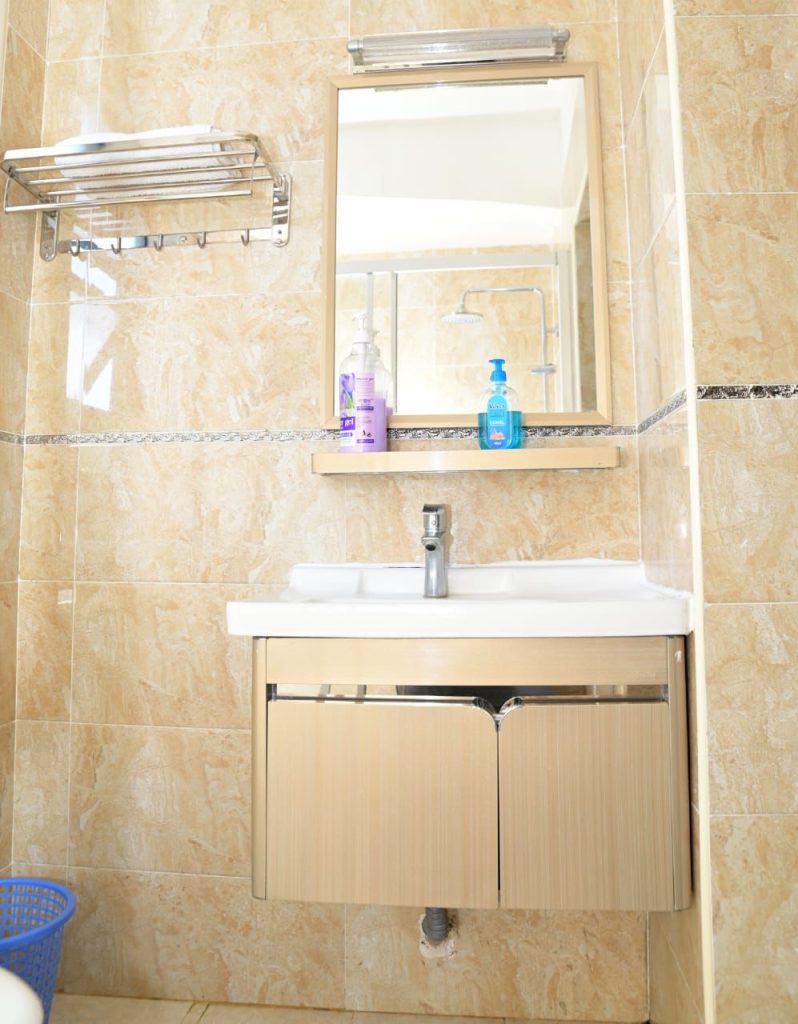 a sink with a mirror at Best Daily and Monthly Rental in Kilimani Nairobi