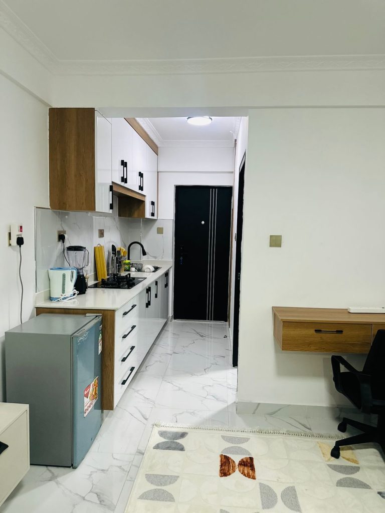 open plan kitchen fitted with appliances and cabinets at the Furnished Studio Airbnb in Kilimani Nairobi