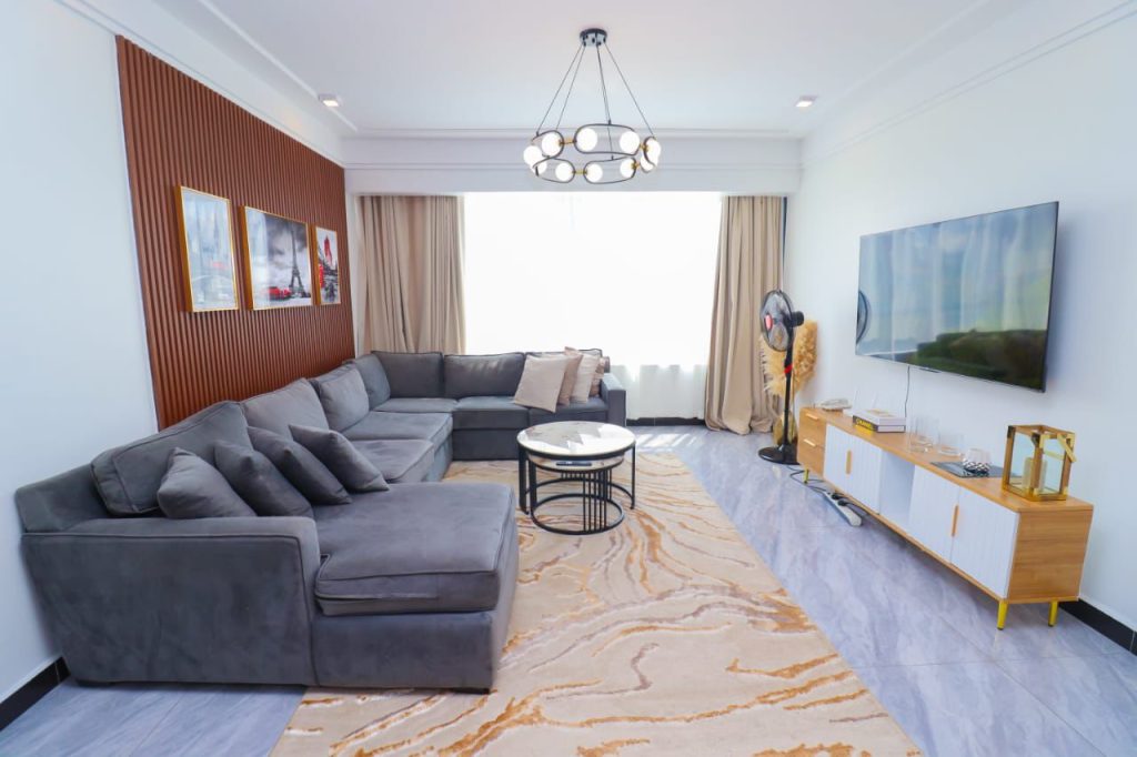 living room and large windows at Furnished 3 Bedroom Airbnb in Kilimani