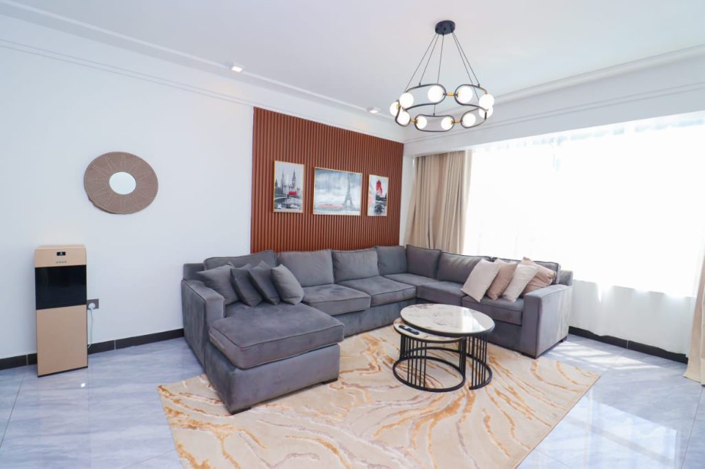 a couch in the living room at Furnished 3 Bedroom Airbnb in Kilimani