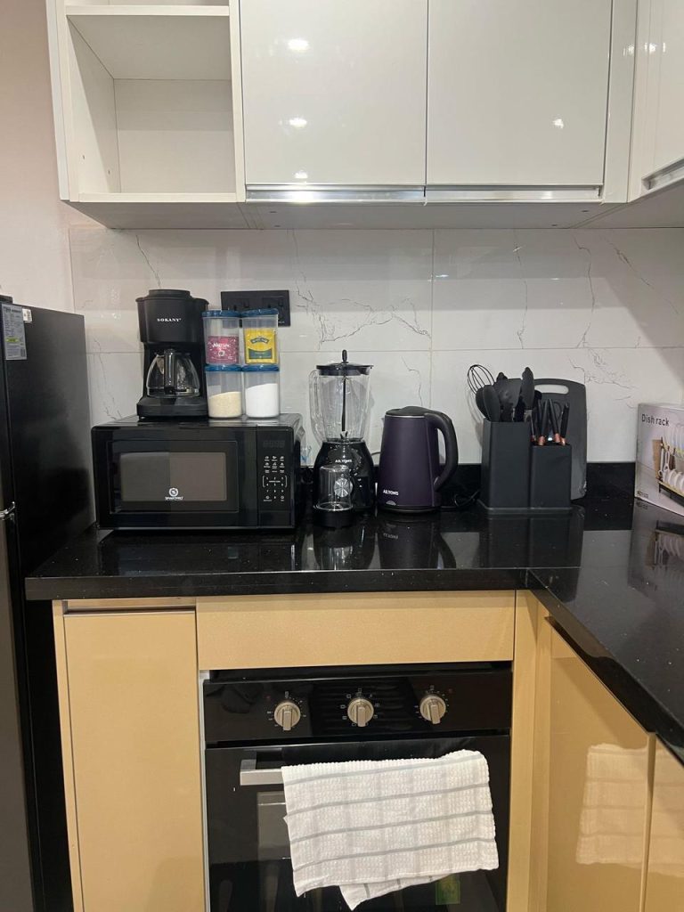 provisions at the kitchen of the Airbnb-style Furnished Apartment in Lavington including a microwave,coffee maker,electric kettle and cutlery