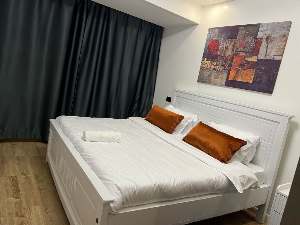 A king size bed in a bedroom inside the Airbnb-style Furnished Apartment in Lavington