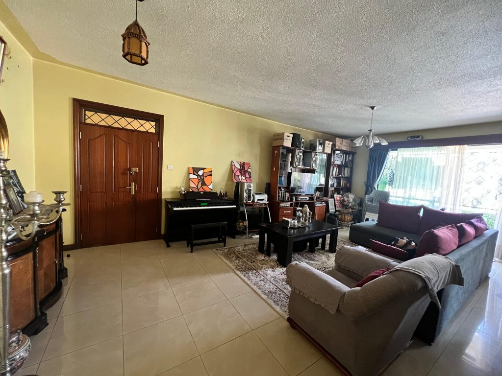 the view of the bright living room with large windows at White Oak Park Apartments in Kilimani