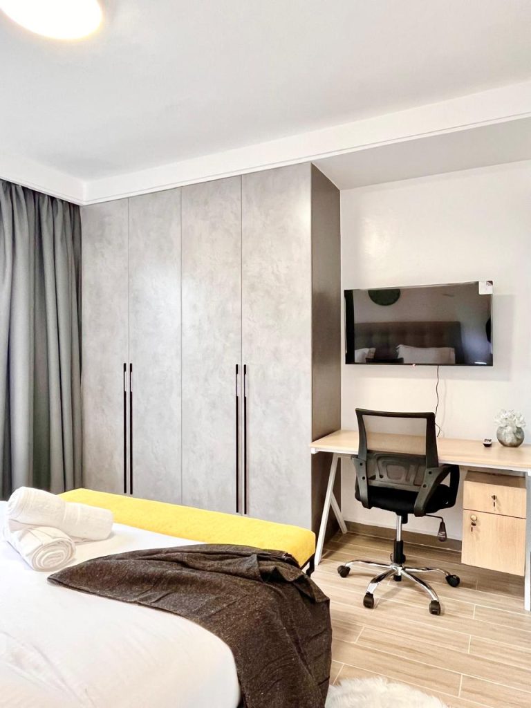 the view of the inbuilt wardrobes and the study desk an a bedroom at Short-Term Accomodation Furnished Apartment in Westlands
