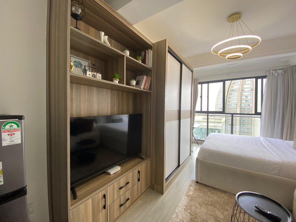 a smart tv and inbuilt cabinets at Studio Apartment in the Heart of Kilimani Nairobi