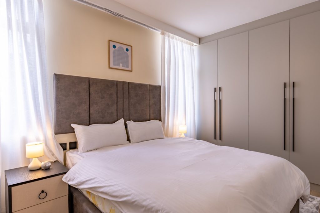 A bedroom with inbuilt cabinets at greenvile apartment