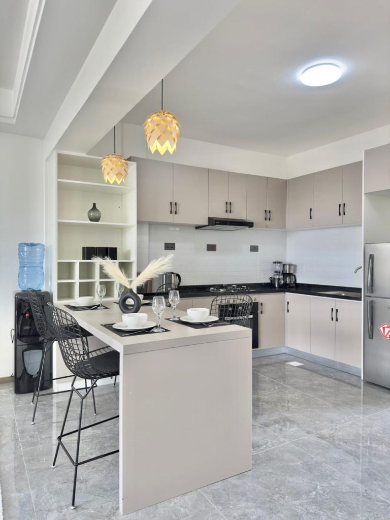 an open plan kitchen island fitted with cabinets and appliances at the Business accommodation near Yaya Centre Kilimani