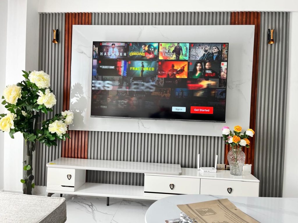 a mounted smart tv and a tv console at Premium Rental Home in Kilimani for professionals