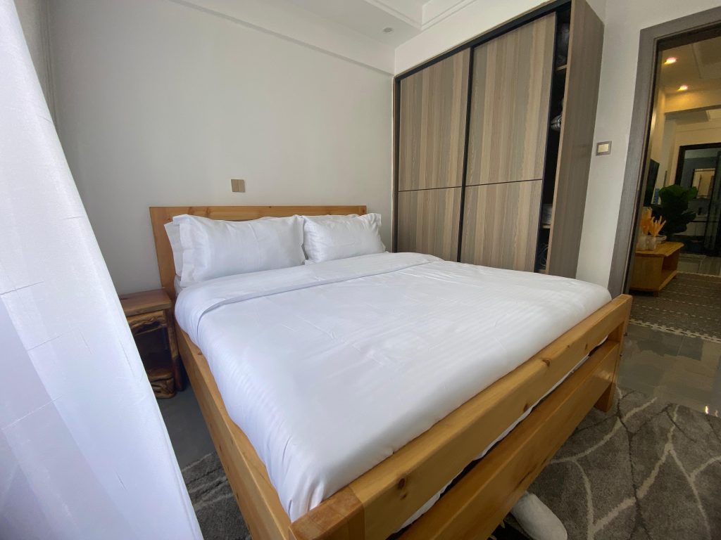 bedroom with the view of the inbuilt cabinets at Serviced apartment in Lavington
