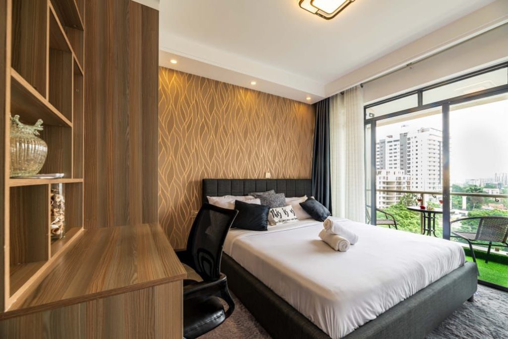 view of the bedroom and study desk with a chair at Furnished Studio Apartment in Lavington