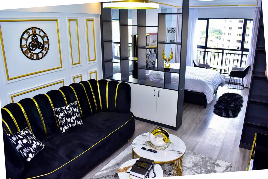 Cozy couchFurnished Studio Apartment off Oloitoktok Road in sitting area separated from bedroom in Airbnb Apartment in Kileleshwa Nairobi.