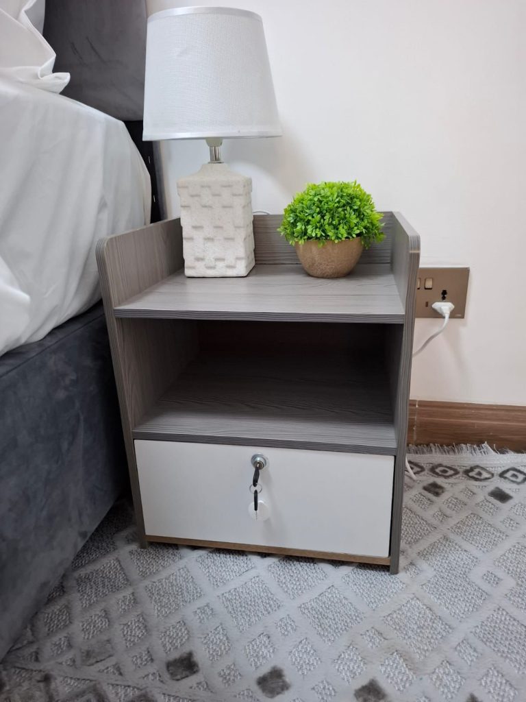 Bedside table with switch lights in a bedroom of 2 Bedroom Corporate Housing in Kilimani Nairobi.