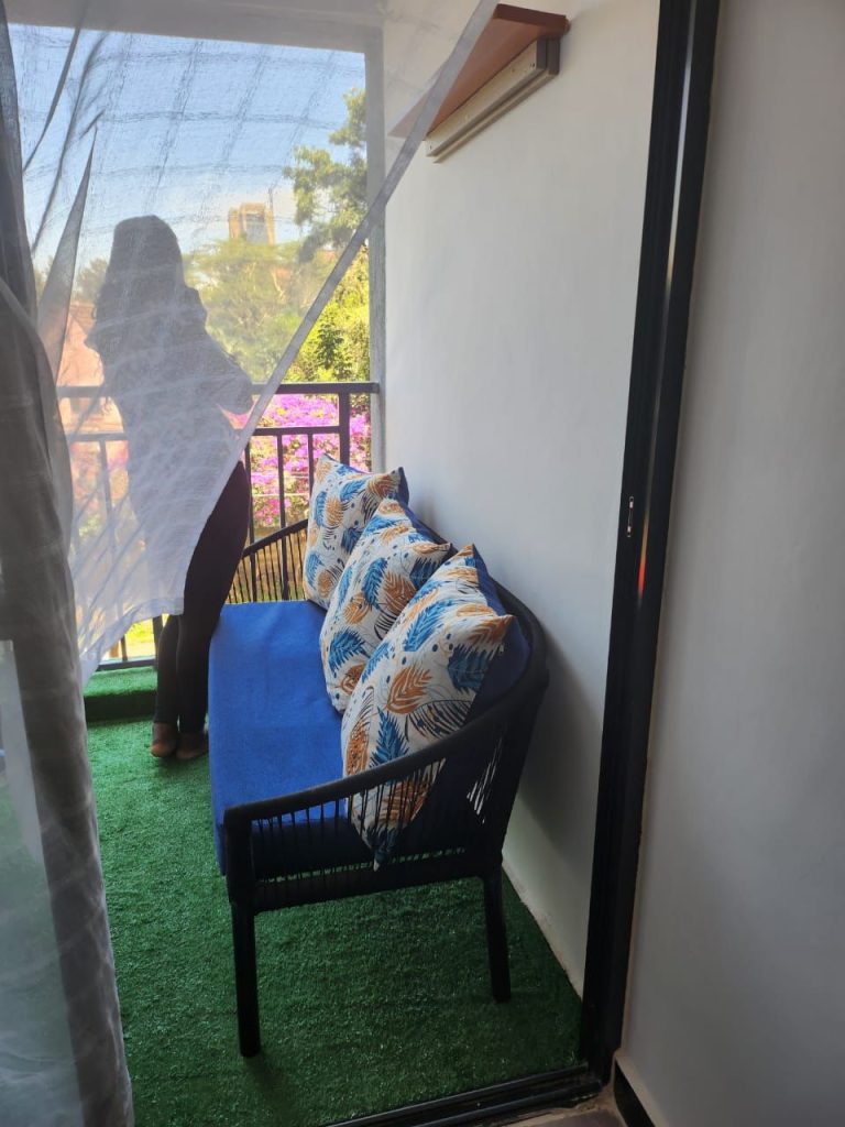 Beautiful balcony with colorful couch in a serviced 2 bedroom apartment in Kilimani Nairobi