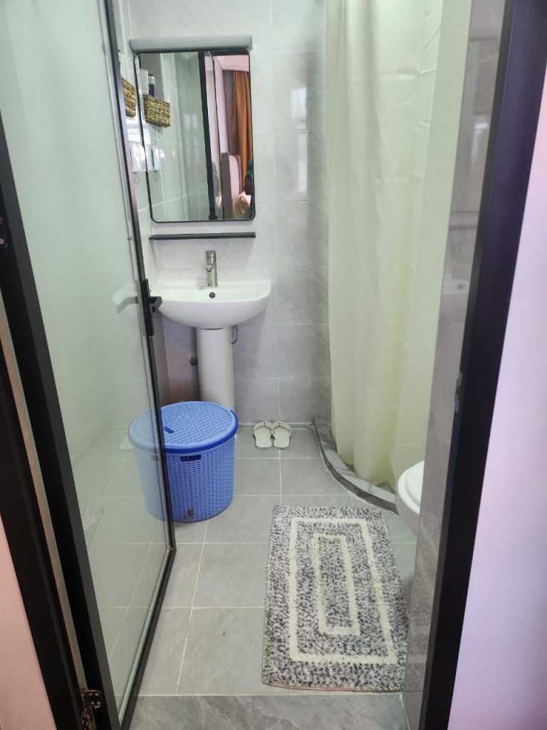 Modern bathroom with cubicle shower and sink in a serviced 2 bedroom apartment in Kilimani Nairobi
