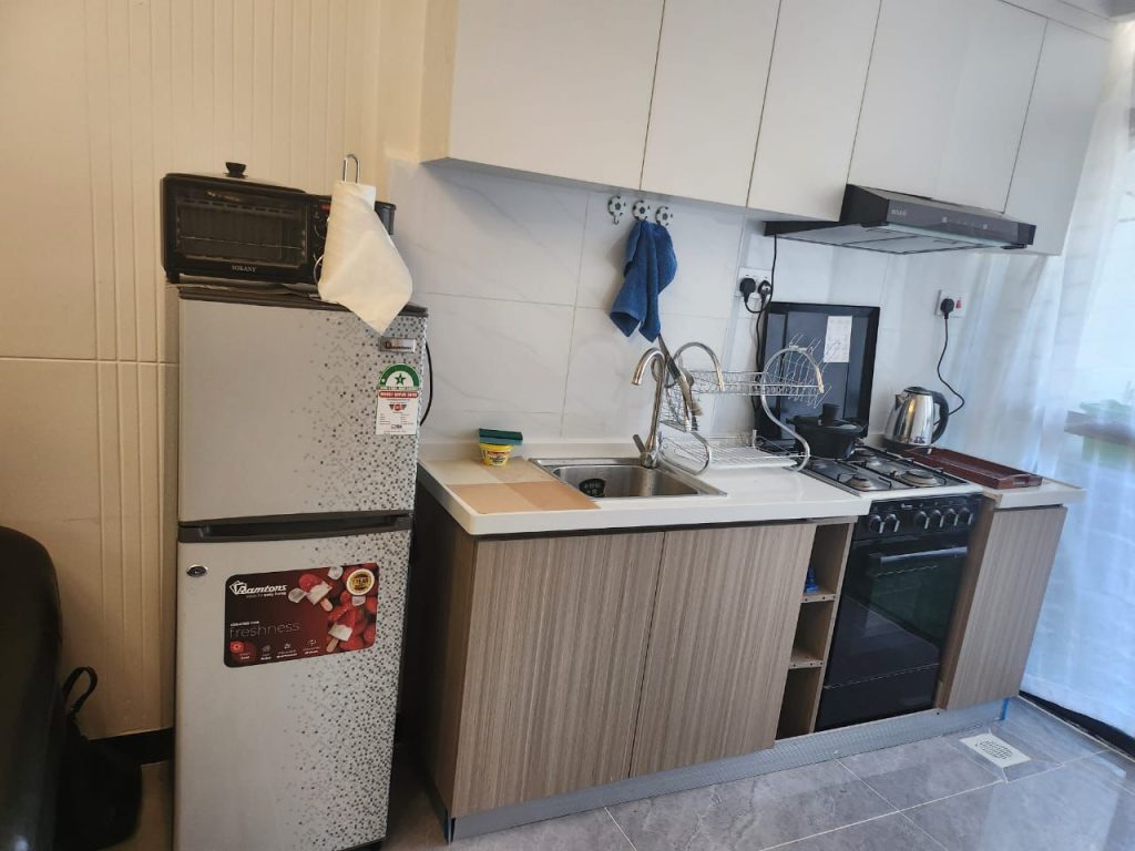 Open plan fitted kitchen with appliances in a serviced 2 bedroom apartment in Kilimani Nairobi