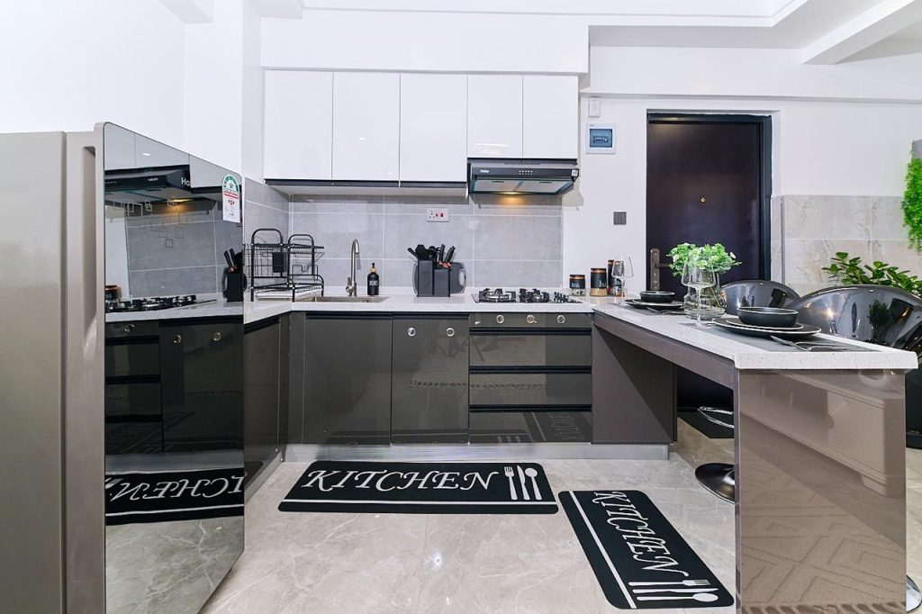 classic open plan kitchen with fiited white cabinets at pay per night apartment in lavington nairobi