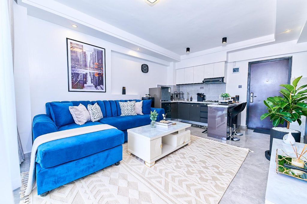 Comfortable blue couch in stylish Lavington Nairobi pay per night apartment.