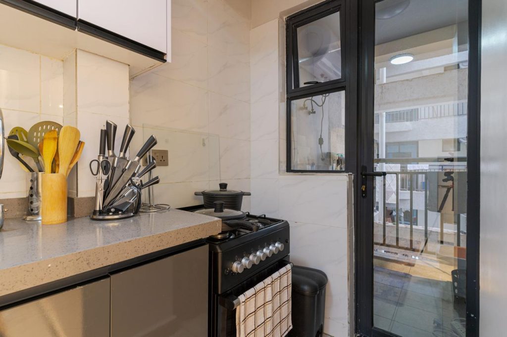 Open-plan kitchen with modern appliances in a furnished apartment in Kileleshwa for rent.