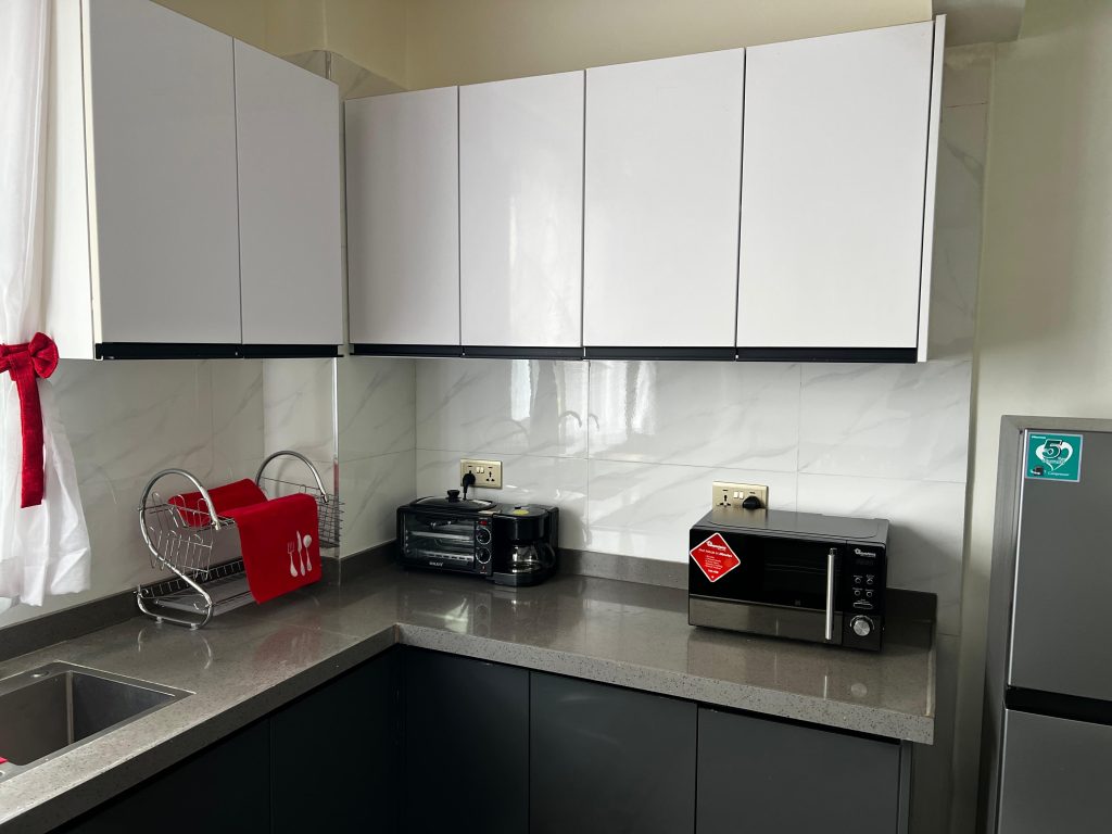 Modern open-plan kitchen with appliances and cabinets in a short stay 2 bedroom apartment in Kileleshwa Nairobi