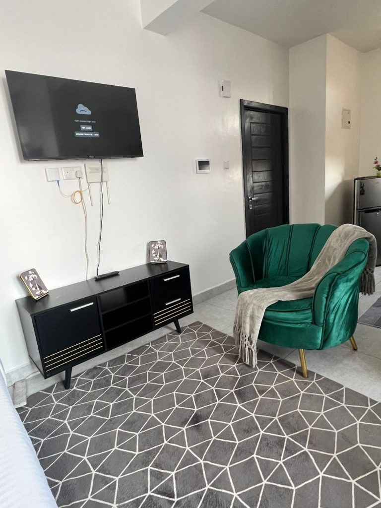 spacious living area with a smart tv at Furnished Apartment Under 100k per Month in Nairobi