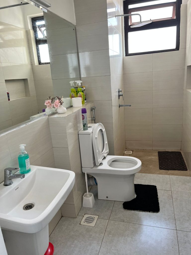 Furnished Apartment Under 100k per Month in Nairobi a bathroom, toilet and sink