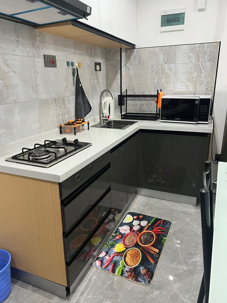 Modern open plan kitchen in 1 Bedroom Furnished Apartment in Kileleshwa with fitted appliances and sleek cabinetry.